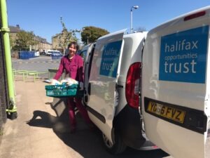Community Organiser, Alison, loads our van with food deliveries during lockdown.