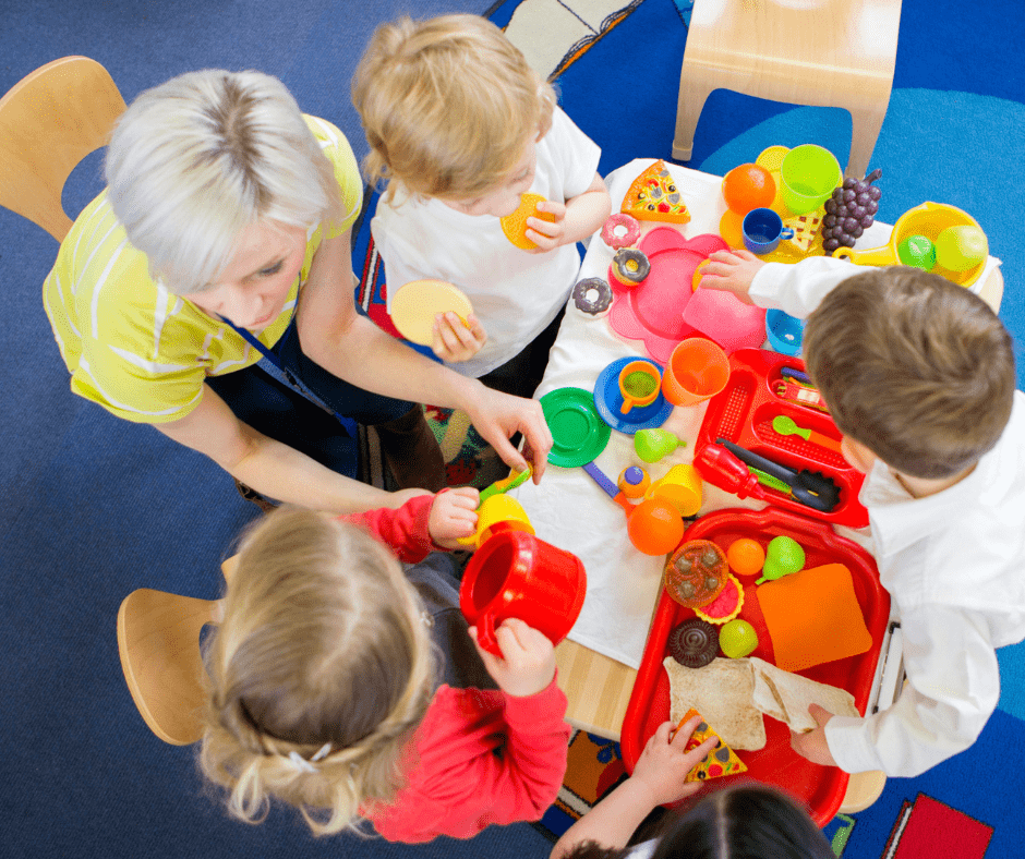 An early years practitioner supporting children in a childcare setting